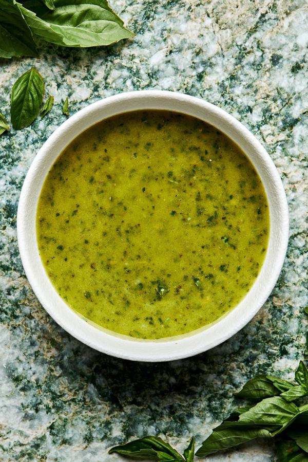 homemade basil vinaigrette in a small bowl made with garlic, lemon zest & Juice, basil, olive oil, sugar, salt and pepper