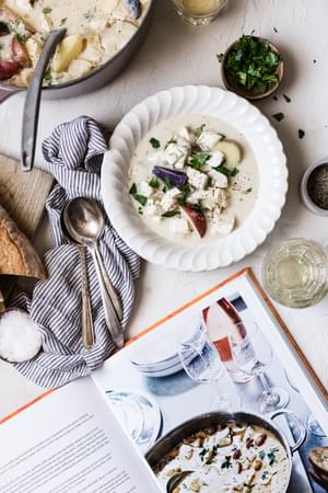Bourride French Fish Stew with aioli and potatoes in bowls net to a Le Creuset cookbook