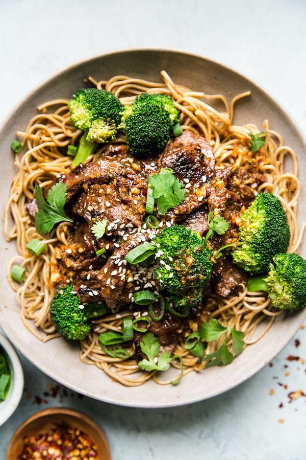 Broccoli and beef soba noodles in a bowl with sesame seeds
