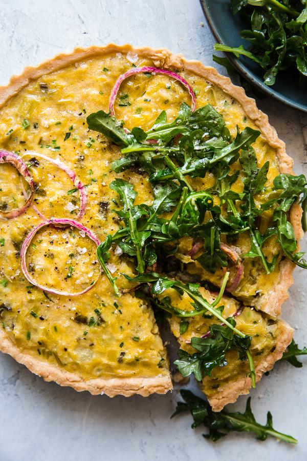 Tart made with chives, red onions, leeks, topped with Arugula Salad