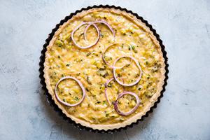 raw onion tart ready to be baked