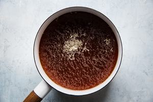 au jus sauce in a pan for french dip sandwiches