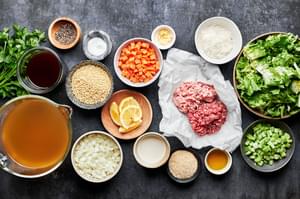 bread crumbs, ground pork, ground beef, parmesan, spices, onion, celery, carrots and chicken stock in bowls