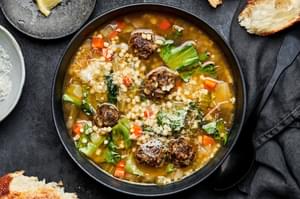 homemade italian wedding soup made with celery, onion, carrots, meatballs and escarole