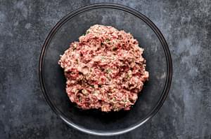 ground pork, ground beef, parsley, parmesan, heavy cream, breadcrumbs, garlic, salt, and pepper in a bowl for meatballs