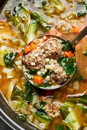 homemade italian wedding soup made with celery, onion, carrots, meatballs and escarole