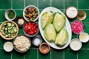 ice berg lettuce wedges, feta, tomatoes, cucumber, pickled onions, olives, cream, lemon juice, chives, & dill in prep bowls
