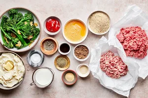 ground beef and pork, beaten egg, breadcrumbs, milk, ketchup, brown sugar, worcestershire & spices in bowls for mini meatloaf