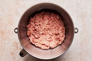 ground beef, ground pork, breadcrumbs, ketchup egg, milk and spices combined in a mixing bowl to make mini meatloaf