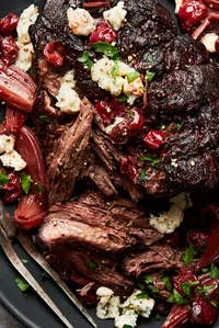 Pot Roast with Tart Cherry-Black Pepper Sauce topped with parsley and gorgonzola cheese