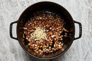 onions and garlic being cooked in a skillet