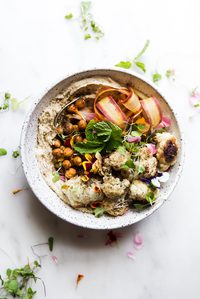 roasted cauliflower and hummus bowl with carrots, mint and spiced chickpeas.
