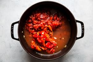 stock, roasted red peppers, fire roasted tomatoes, garlic and onions in a soup pot for roasted red pepper soup