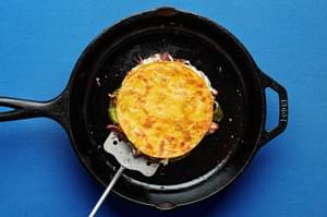 roasted poblano and carnitas quesadillas being cooked in a skillet