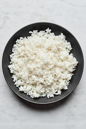 homemade sushi rice in a serving bowl made with salt, sugar and rice vinegar