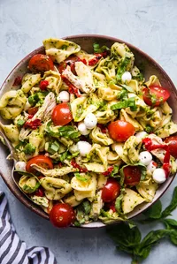 tortellini pasta salad with tomatoes, and basil and pesto