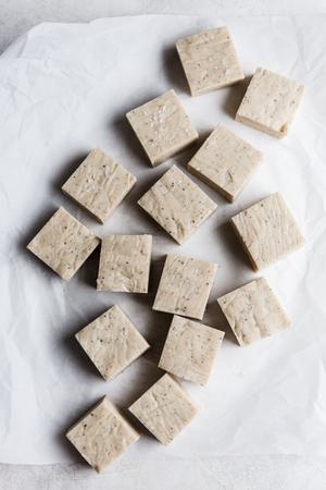 white chocolate chai fudge cut into squares on parchment paper