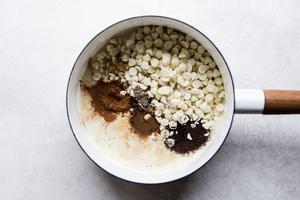 sweetened condensed milk, white chocolate chips, vanilla, cinnamon, salt, cardamom, ginger, cloves, black tea in a pan