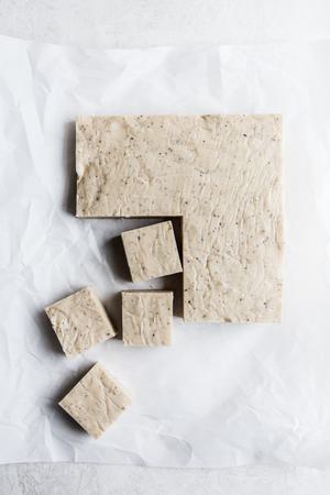 white chocolate chai fudge cut into squares on parchment paper