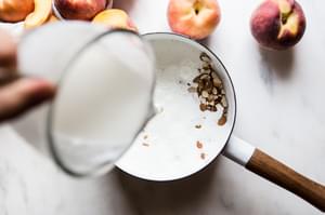 milk and heavy cream cooked in a sauce pan with almonds