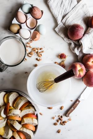eggs, peaches, almonds, milk and cream for make bread pudding