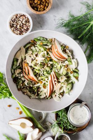 Celery Pear Salad with hazelnuts fennel and tarragon in a bowl