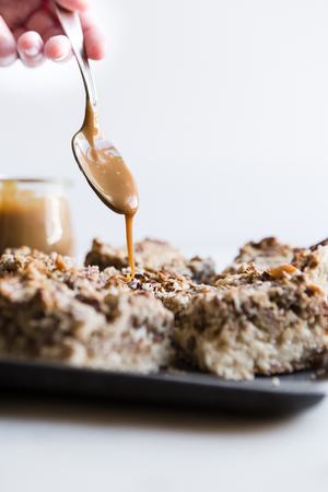 Coconut Pecan Caramel Bars being drizzled with caramel
