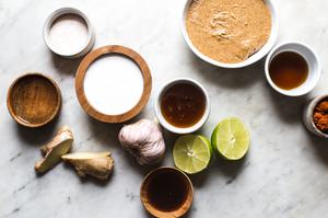 almond butter, garlic, lime juice, Coconut milk, honey, sesame oil, Coconut aminos, ginger, vinegar, Red curry paste, Salt