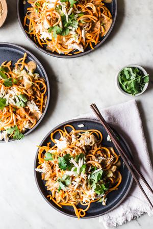 Pad Thai made with sweet potato noodles with cilantro and lime on a plate