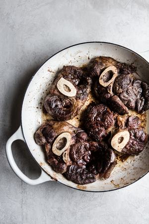 4 cross cut beef shanks browned in a braiser.
