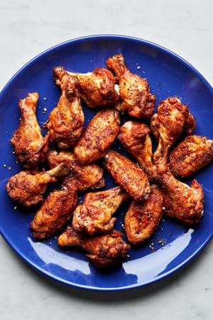 Homemade baked chicken wings on a plate seasoned with salt, pepper, garlic powder, paprika and cayenne