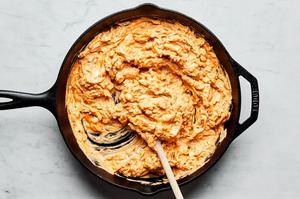 chicken, buffalo sauce, cream cheese, sour cream, cheddar, mozzarella, blue cheese and spices stirred in a skillet