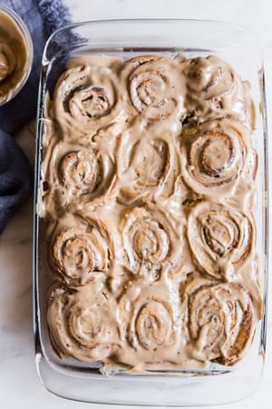 Coffee Cinnamon Rolls With Maple Cream Cheese Icing in a baking dish