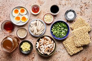 ramen noodles, chicken, mushrooms, green onions, chicken stock, soy sauce, ginger, garlic & eggs in prep bowls to make ramen