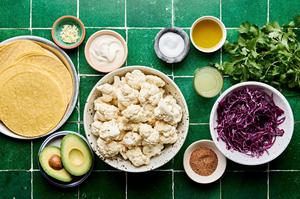 cauliflower, tortillas, taco seasoning, cabbage, cilantro, avocado, garlic, sour cream, salt, lime juice & cilantro in bowls