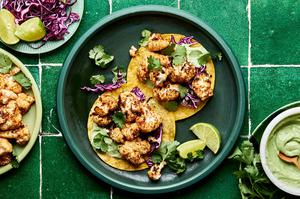 roasted cauliflower tacos on corn tortillas topped with shredded cabbage, cilantro & avocado crema. Served with lime wedges.