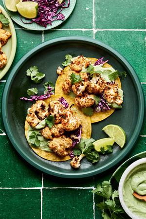 roasted cauliflower tacos on corn tortillas topped with shredded cabbage, cilantro & avocado crema. Served with lime wedges.