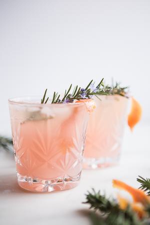 2 glasses of Grapefruit Cardamom Gin Fizz with rosemary