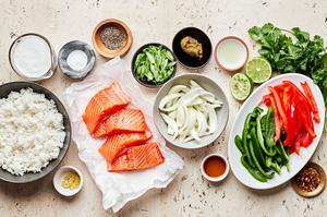 salmon, peppers, onions, rice, fish sauce, green curry paste, lime juice, coconut milk and ginger in prep bowls