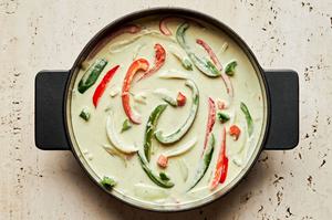 coconut milk, curry paste, lime juice, ginger, fish sauce, peppers and onions in a large pot