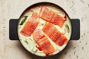coconut milk, curry paste, lime juice, ginger, fish sauce, peppers, onions and salmon in a large pot