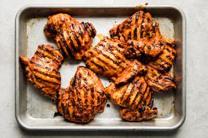 grilled harissa chicken on a baking sheet