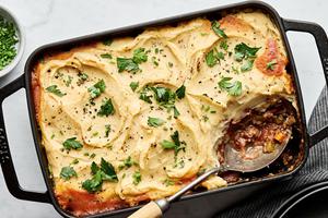 healthy shepherd's pie in a baking dish made with ground beef, onion, carrots, cabbage topped with mashed parsnips