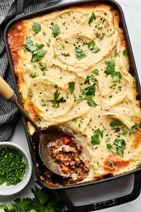 healthy shepherd's pie in a baking dish made with ground beef, onion, carrots, cabbage topped with mashed parsnips