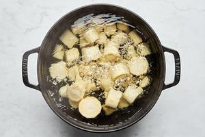 parsnips being boiled in a pot of water