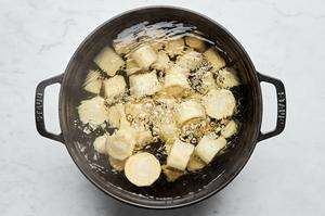 parsnips being boiled in a pot of water