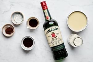 condensed milk, Irish whiskey, chocolate syrup, vanilla extract, instant coffee, coconut cream and heavy cream in bowls