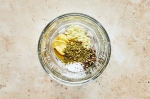 dijon, chopped garlic, salt, pepper and oregano in bowl for making homemade Italian salad dressing