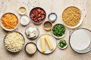 macaroni, bacon, jalapeño, butter, flour, milk, cream cheese, cheddar and pepper jack in prep bowls