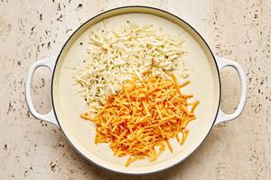 cheese sauce in a pot being made with butter, flour, cream cheese, cheddar and pepper jack